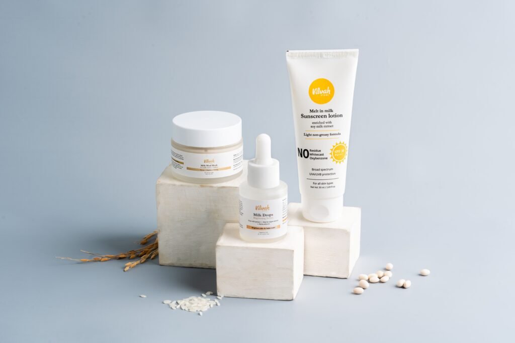Elegant skincare and sunscreen products on a gray backdrop. Ideal for beauty marketing.